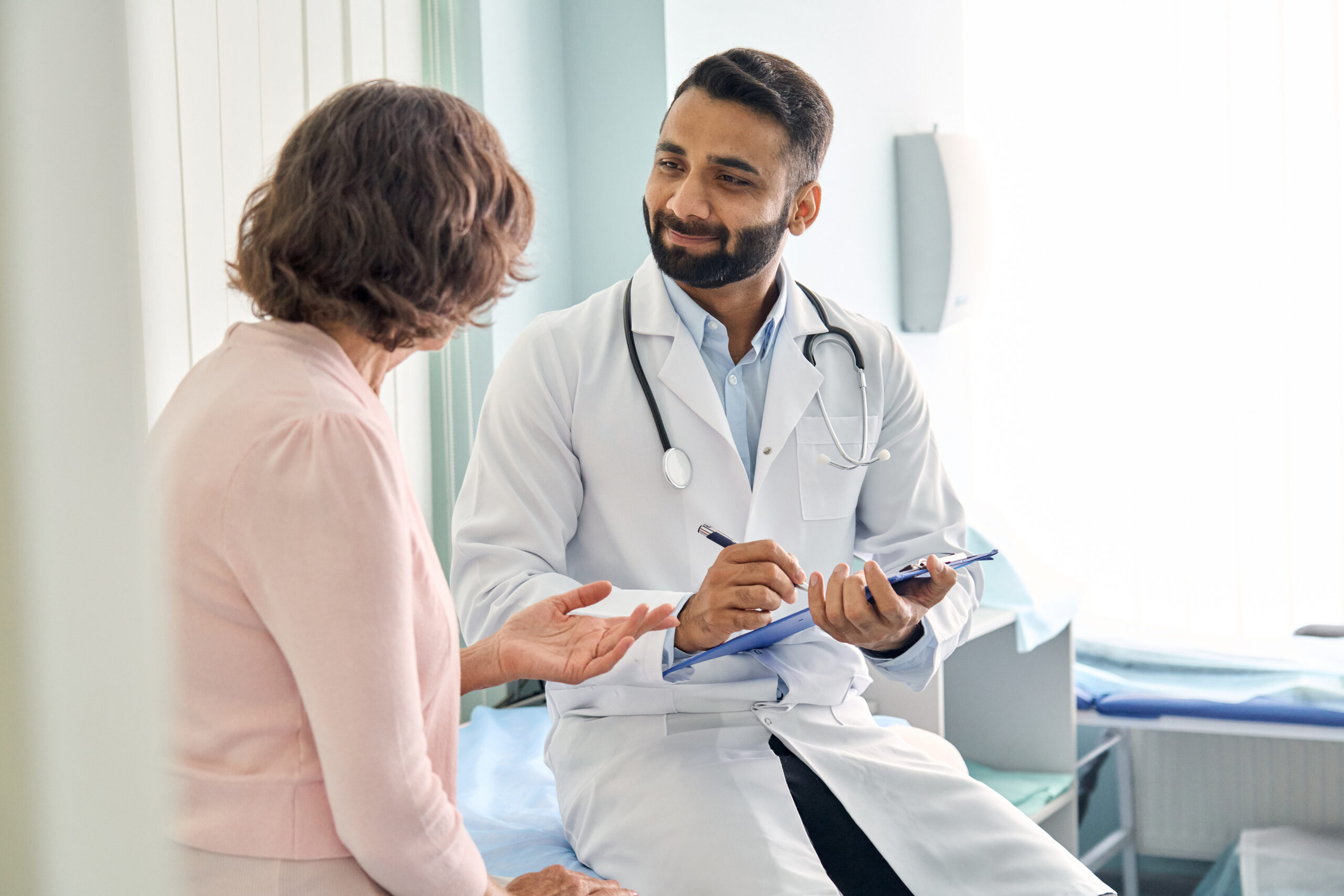 Doctor talking with patient in exam room